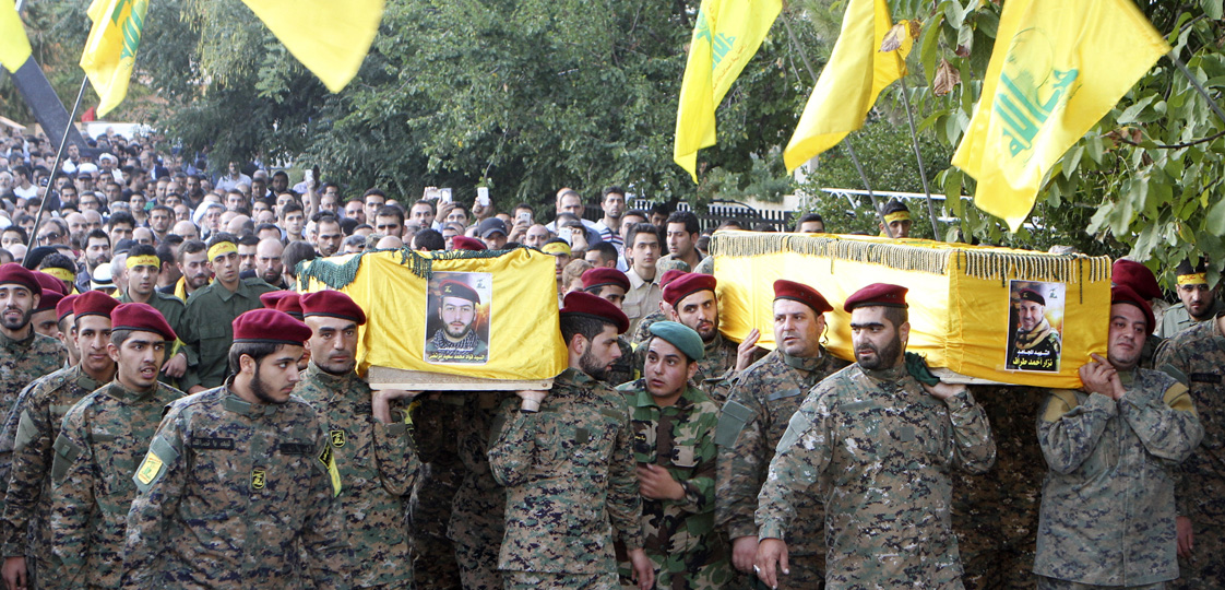 Lebanon's Hezbollah members carry the coffins of two of their comrades, who were killed in clashes with fighters from the Nusra Front in eastern Lebanon, during their funeral in Baalbek, in the Bekaa valley October 6, 2014. Ten fighters from Lebanon's Shi'ite Hezbollah group were killed in clashes with fighters from al-Qaeda's Syrian wing in eastern Lebanon on Sunday, a source close to the group said on Monday. The Qaeda fighters, who see Hezbollah as among their chief foes, attacked a large area stretching from south of the town of Baalbek up to areas close to the border town of Arsal. REUTERS/Ahmad Shalha 
