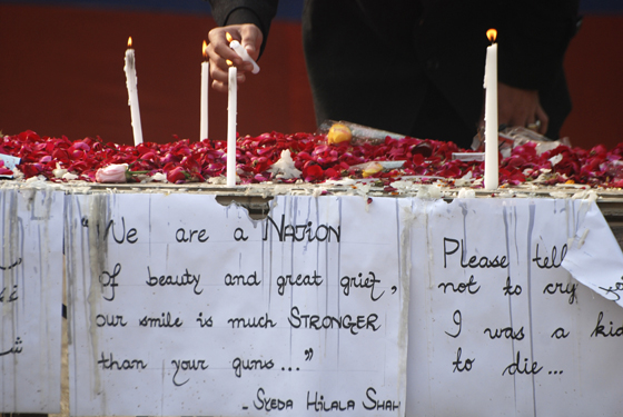 Peshawar, Pakistan A student lights candles for the victims of Army Public School which was attacked by Pakistan's Taliban gunmen, in Peshawar December 23, 2014. REUTERS/Khuram Parvez 