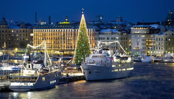 A 36-metre tall Christmas tree is lit up in central Stockholm. REUTERS/Claudio Bresciani/Scanpix Sweden