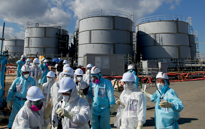 Journalists in protective clothing on a visit to the nuclear power station of Fukushima Daiichi. Although the radiation from the Fukushima disaster doesn’t appear to have caused any deaths, the reclamation costs have been crippling and the environmental impact is expected to be severe.
