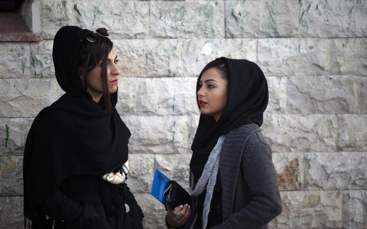 Two Iranian women talk at a corner of a square in northern Tehran February 26, 2012.