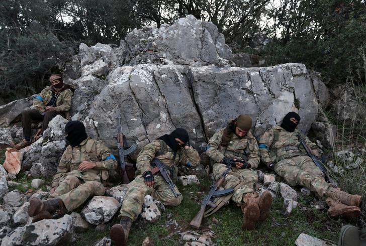 Combattenti dell'esercito siriano libero sostenuti dalla Turchia riposano vicino alla città di Afrin, in Siria, il 19 febbraio 2018. REUTERS / Khalil Ashawi