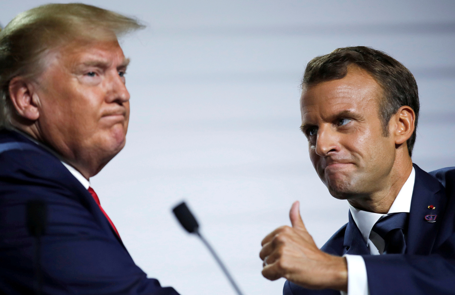 Il Presidente francese Emmanuel Macron e il Presidente degli Stati Uniti Donald Trump reagiscono durante una conferenza stampa al termine del vertice del G7 a Biarritz, Francia, 26 agosto 2019. REUTERS/Carlos Barria